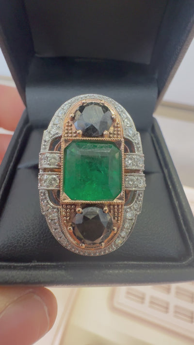 EMERALD, DIAMOND AND BLACK DIAMOND RING